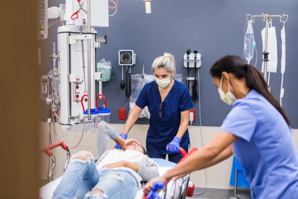 istock Emergency Room Nurses Assisting a Patient on a Stretcher 2202327862
