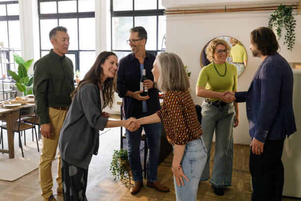 istock Cheerful Guests Arriving at a Loft Dinner Party | Friendship & Celebration 2202328072