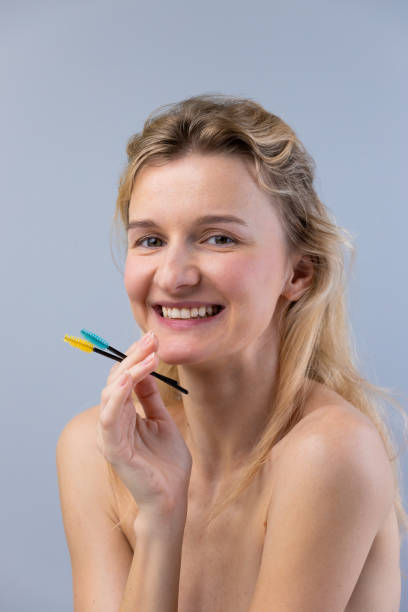 istock A Radiant Smile with Colorful Brushes: Celebrating Beauty and Grooming Techniques in a Minimalist Setting 2202328543