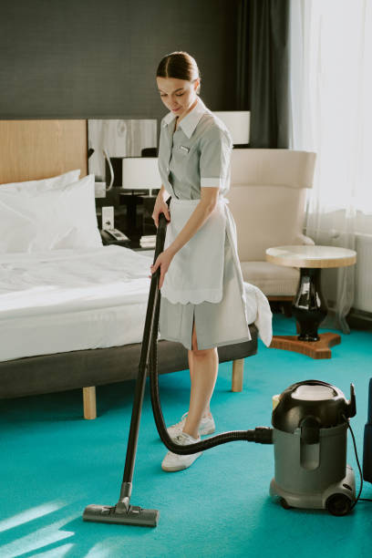 istock Young Chambermaid Using Vacuum Cleaner to Clean Room 2202328707