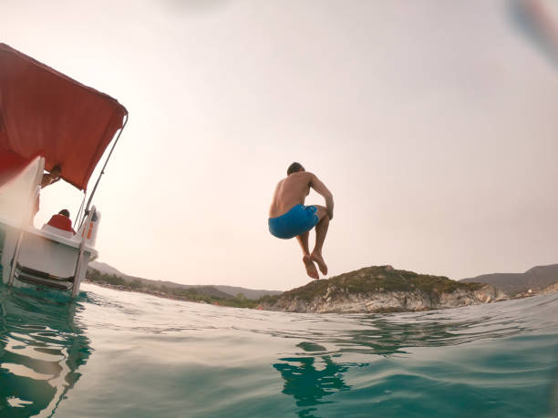 Man jumps in the sea cannonball style.