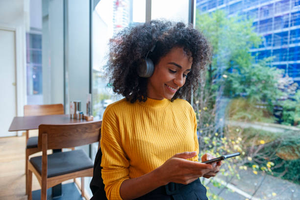 istock Woman using her smartphone in a caffe 2202329999