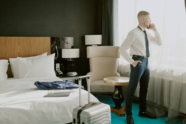 istock Hotel Guest Speaking on Smartphone in Room 2202330185