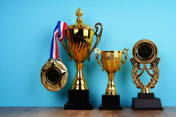 istock Collection of gold trophy and medal on blue background 2202332249