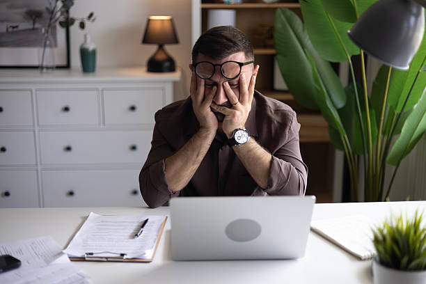 istock Businessman looking at laptop, working online from his home 2202332283