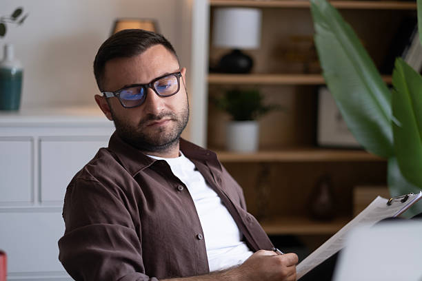 istock Businessman looking at laptop, working online from his home 2202332372