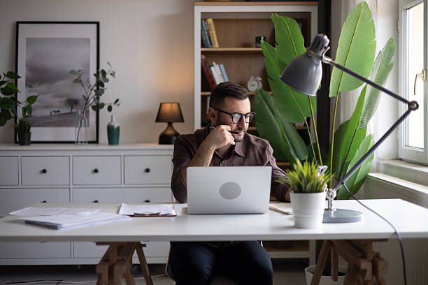 istock Businessman looking at laptop, working online from his home 2202333439