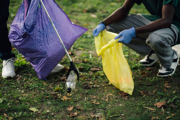 istock Volunteers picking up trash in a public park 2202333606