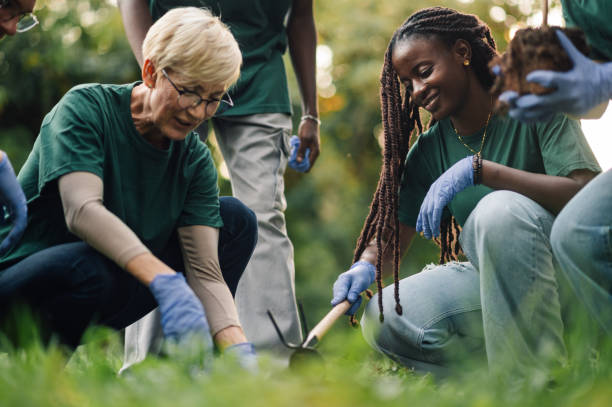 istock Volunteers planting trees in park are saving the planet 2202333607