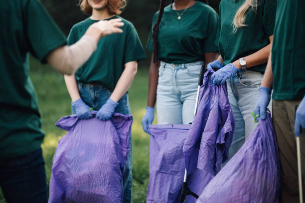 istock Group of volunteers picking up trash in park 2202333630