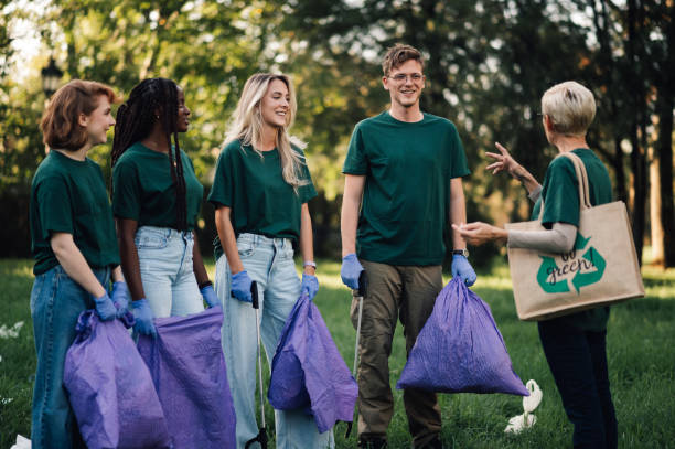 istock Group of volunteers collecting garbage in park 2202333643
