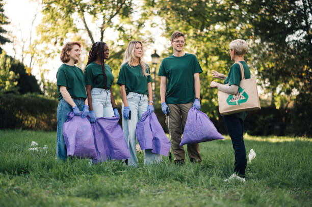 istock Group of people volunteers gathering garbage in park 2202333646