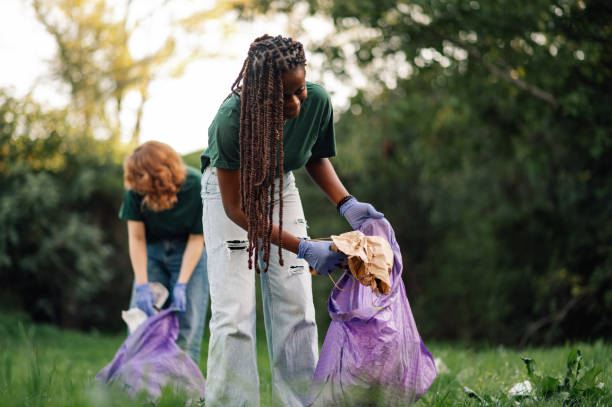 istock Volunteers collecting garbage in public park wearing gloves 2202333656