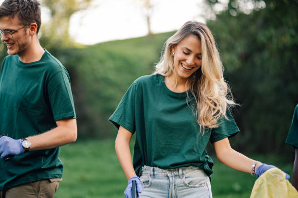 istock Group of volunteers collecting garbage in a park 2202333672