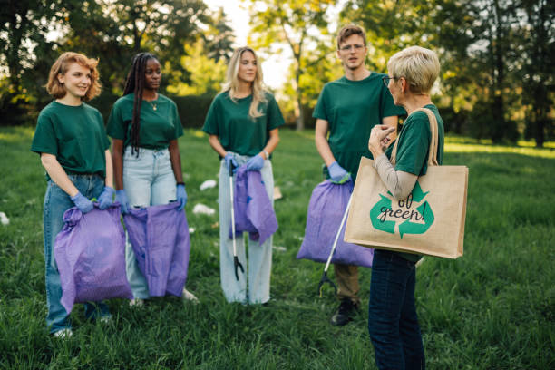 istock Group of volunteers collecting garbage in park 2202333678