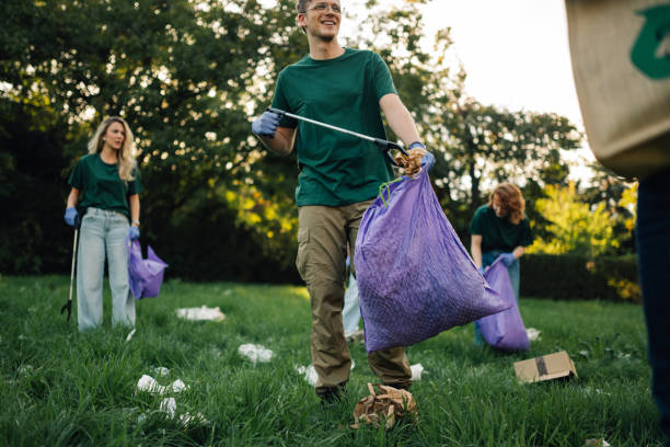 istock Volunteers collecting garbage in park are saving environment 2202333697