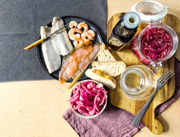 Seafood and pickled onion on bright wooden table, seafood and pickled onion on wooden table in kitchen - healthy eating, lifestyle, copy space
