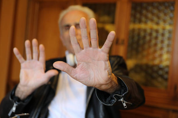 istock Elderly Man Indicating Numbers with His Fingers 2202335180