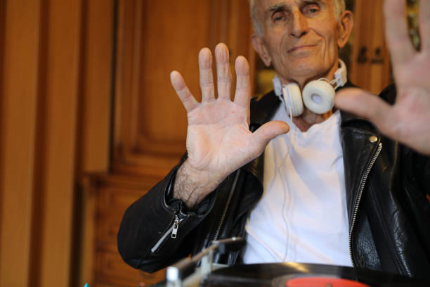 Charismatic disc jockey. Club, disco DJ playing and mixing music for crowd people.