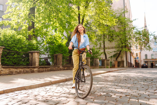 istock A young tourist rides a bicycle through European streets on a sunny day. 2202335607