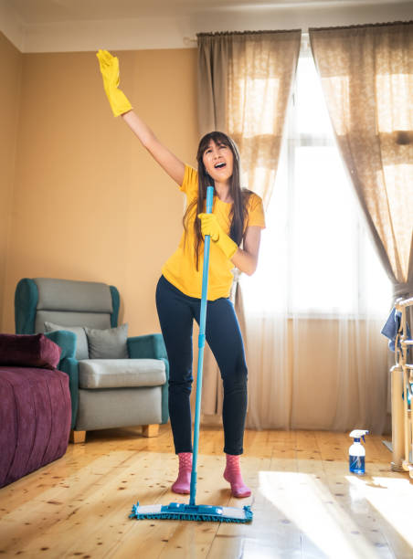 istock Woman singing while cleaning the house 2202335811