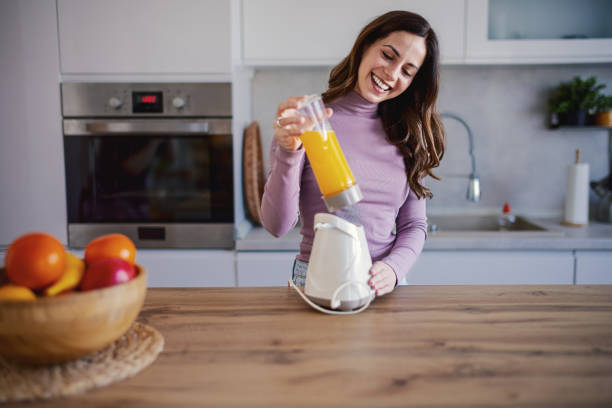 istock Woman preparing a Smoothie Into a Glass 2202336850