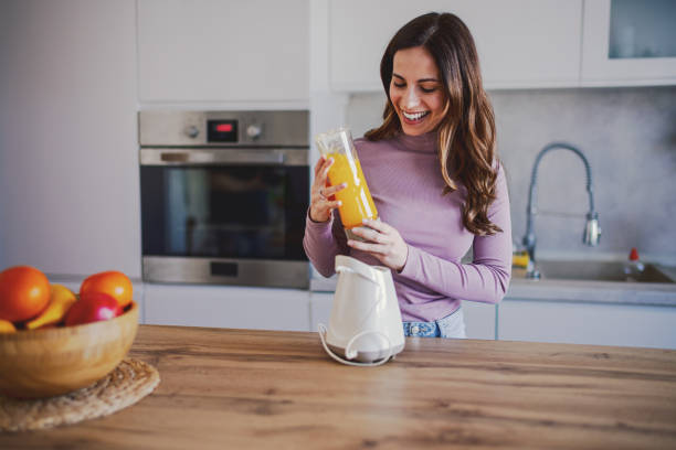 istock Woman preparing a Smoothie Into a Glass 2202336858