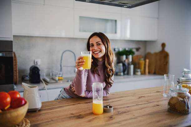 istock Woman preparing a Smoothie Into a Glass 2202337661