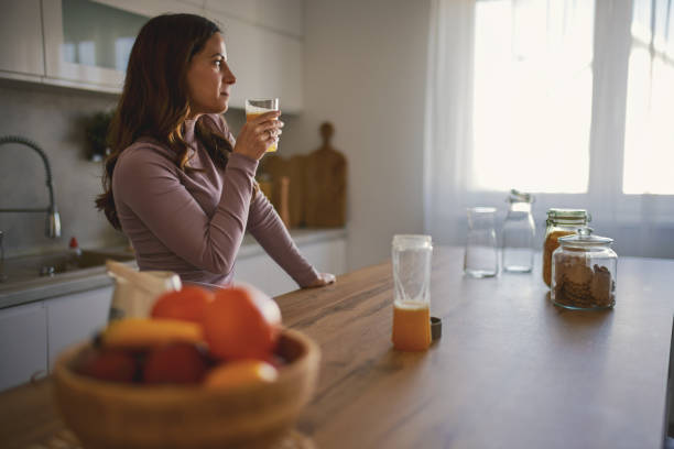 istock Woman preparing a Smoothie Into a Glass 2202337698