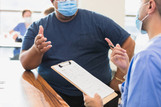 istock Doctor and Patient Discussing Medical Chart During a Consultation 2202340972
