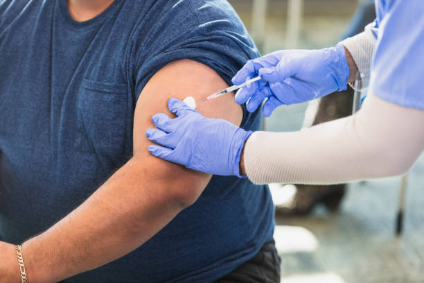istock Healthcare Worker Administering Injection to Patient 2202340976