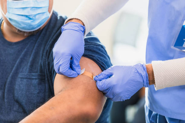 istock Healthcare Worker Applying Bandage After Vaccination 2202340980