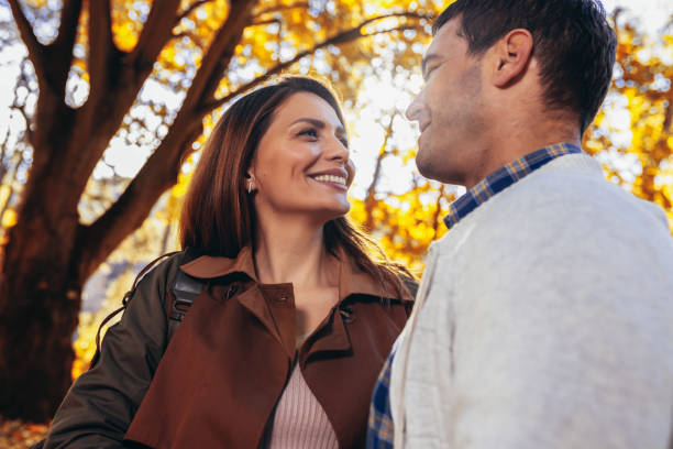 istock Beautiful young couple hugging in autumn park. 2202342211