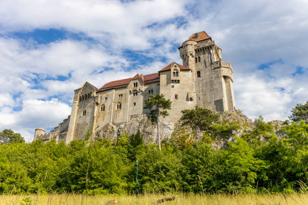 Ancient castles architecture in Europe. Austria medieval citadel made of bricks. Rocky walls of an old historical castle with towers and bridge on a sunny summer day, European landmark and history