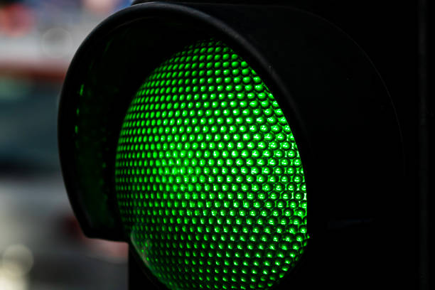 istock Part of a traffic light, with green light turned on 2202343448