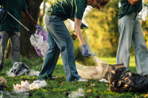 istock Group of volunteers picking up trash in park 2202343945