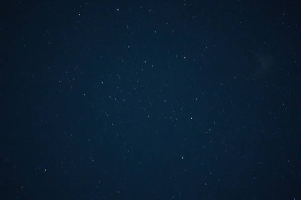 Field of stars in motion with short line on dark blur sky background