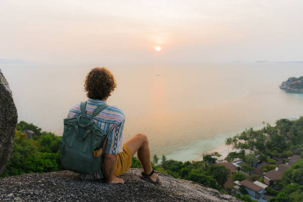 Serene man looking at idyllic beach in Thailand on Ko Phangan