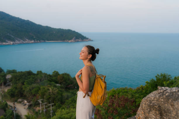 Cheerful woman  looking at seascape at Ko Phangan from viewpoint