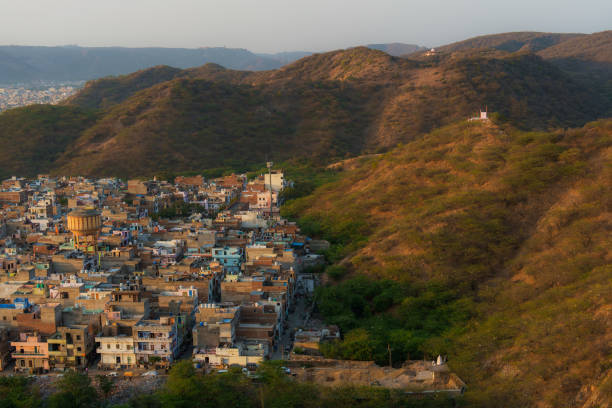 Aerial view of city scape with apartment buildings, under construction buildings and mountains, Pune