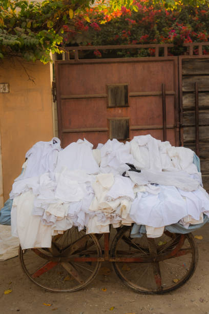 istock Clean white shirts on cart in India 2202348507