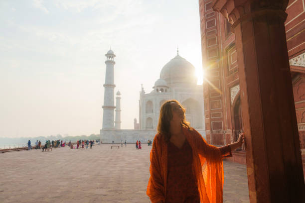 Woman exploring Taj Mahal at sunrise, India
