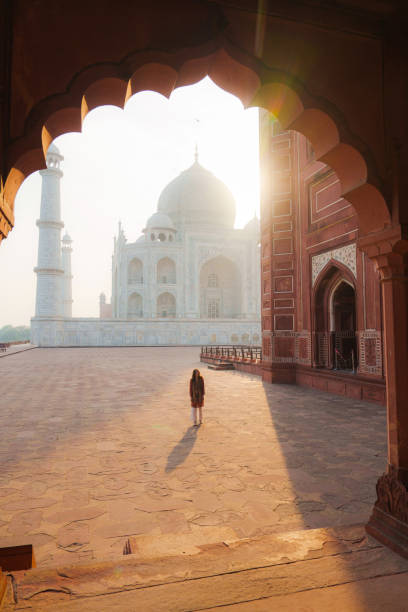 istock Woman exploring Taj Mahal at sunrise, India 2202349802