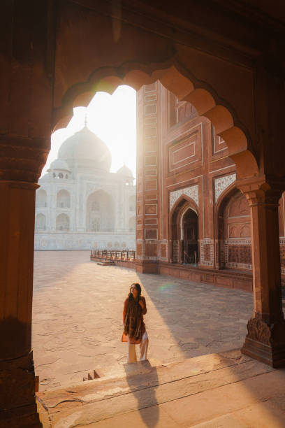 istock Woman exploring Taj Mahal at sunrise, India 2202349811