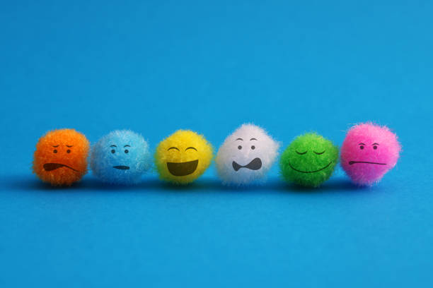 Colorful plush spheres with different facial expressions