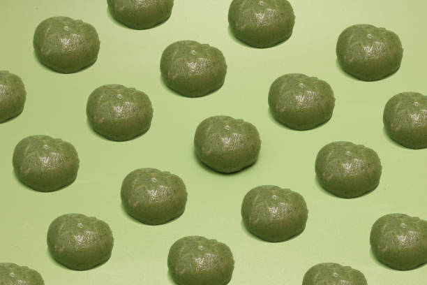 istock Many japanese rice‐flour dumpling mixed with mugwort set in a green background. 2202353695
