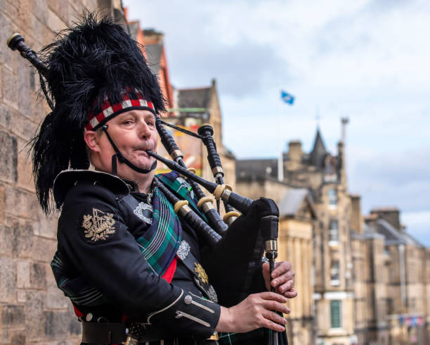 Edinburgh, UK - February 15th 2023: A Bagpiper in traditional uniform, in the city of Edinburgh, Scotland.