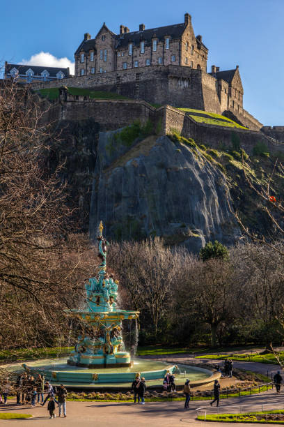 Edinburgh, United Kingdom - May 13, 2019:Restored Ross Fountain in Princes Street Gardens with Edinburgh Castle. Edinburgh, Scotland, UK