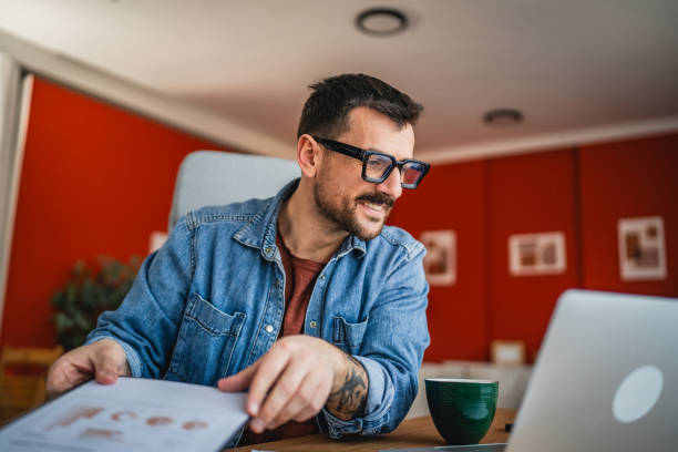 istock focused concentrated man work on clipboard and laptop at home office 2202360814