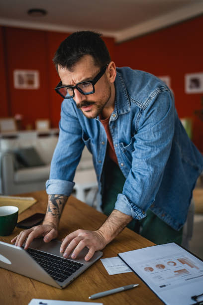 istock focused concentrated man work on laptop from home office 2202361535